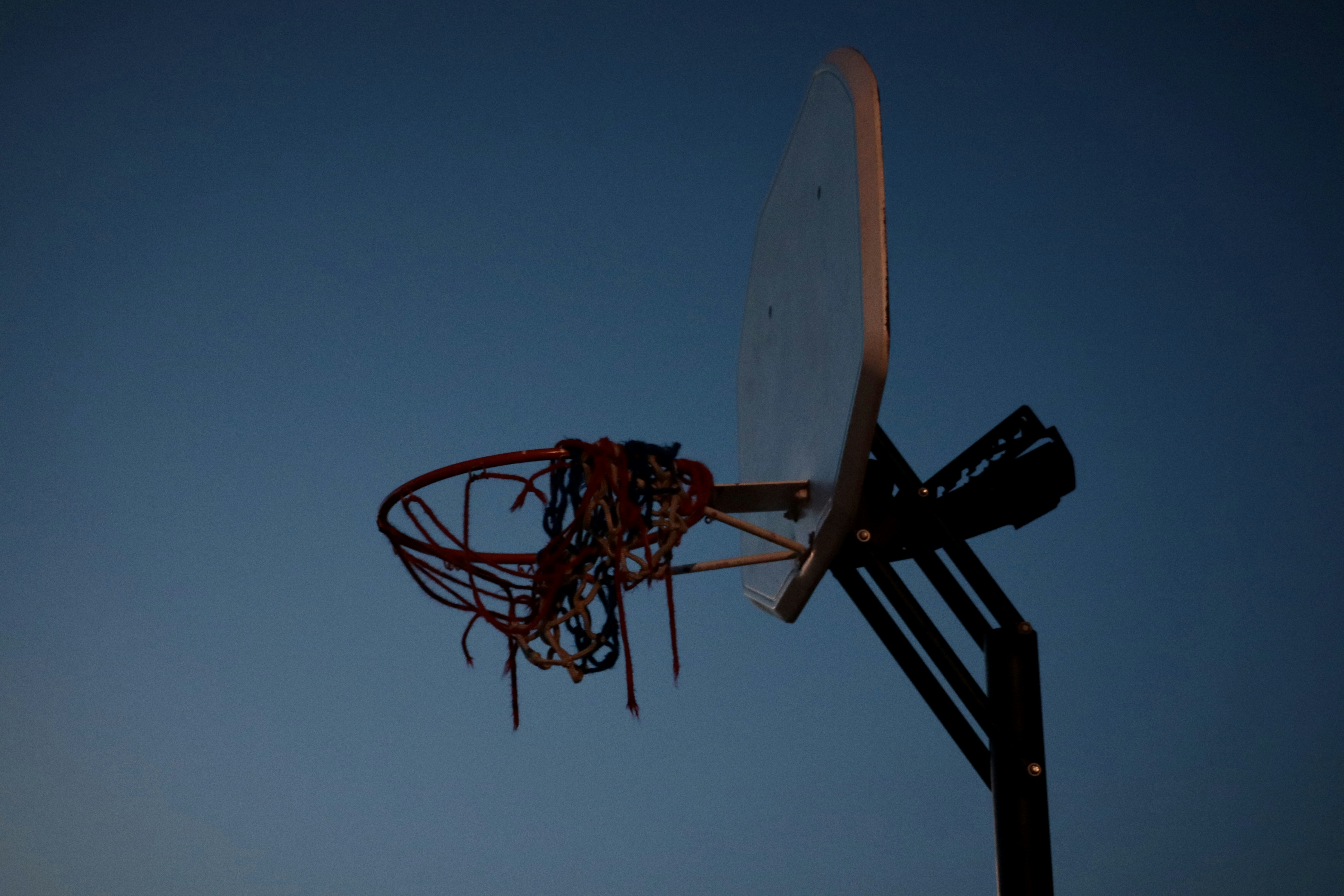 a basketball going through the rim of a basketball hoop