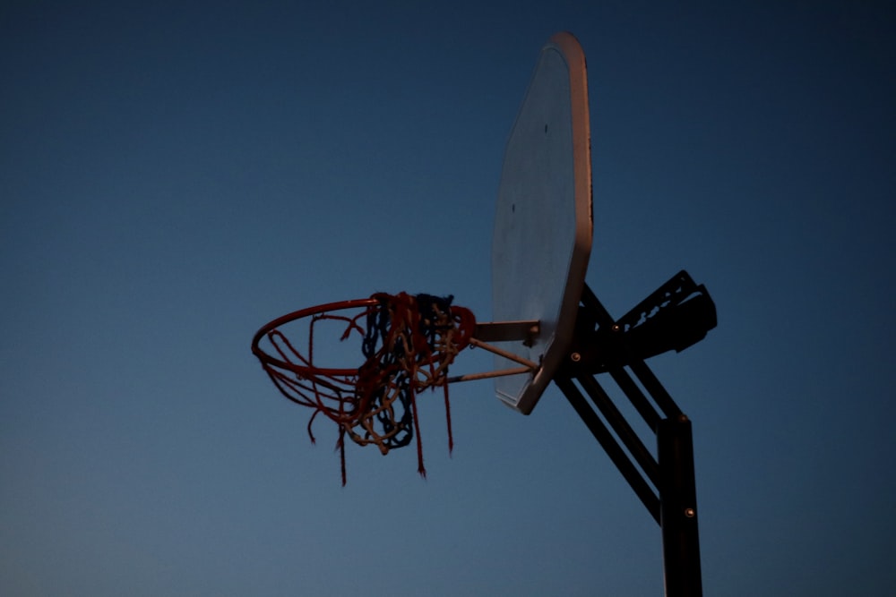 a basketball going through the rim of a basketball hoop