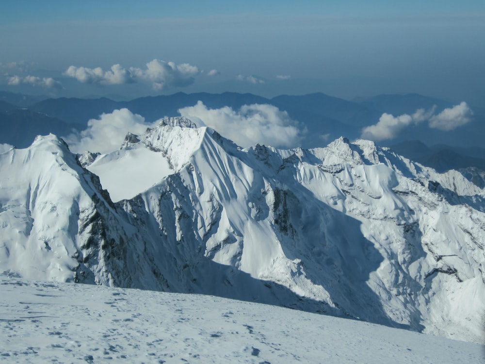 a view of a snow covered mountain from the top of a mountain