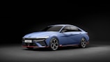 a blue car is shown in the dark