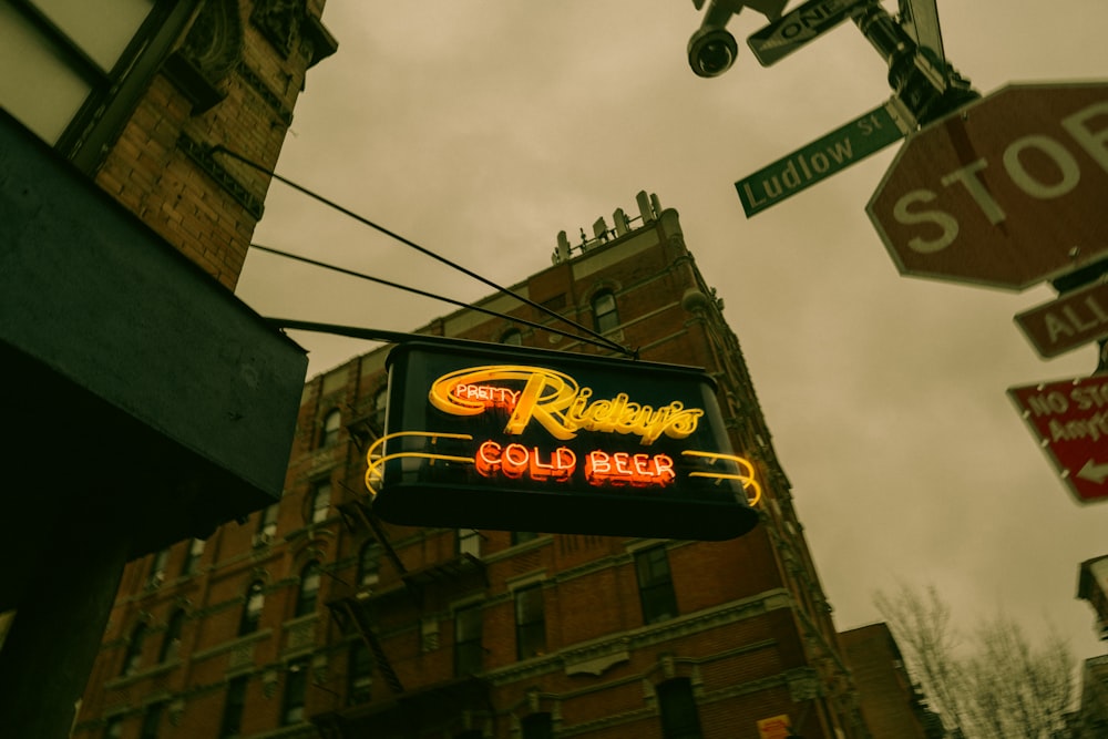 a neon sign hanging from the side of a building