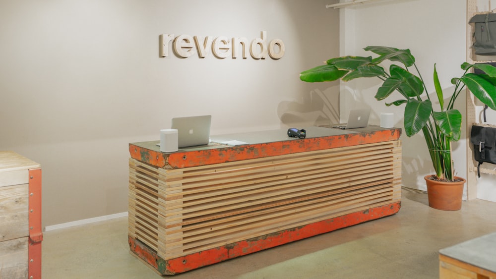 a wooden desk with a laptop on top of it