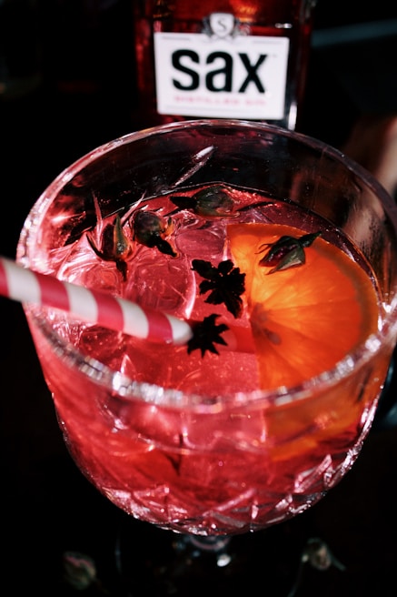 Close-up of a colorful cocktail being served at Bamedson's open bar