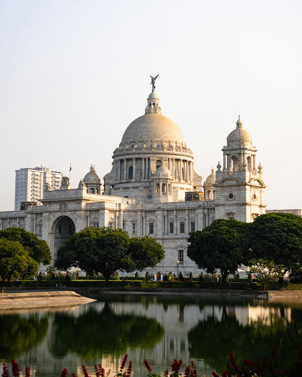 a large white building with a statue on top of it