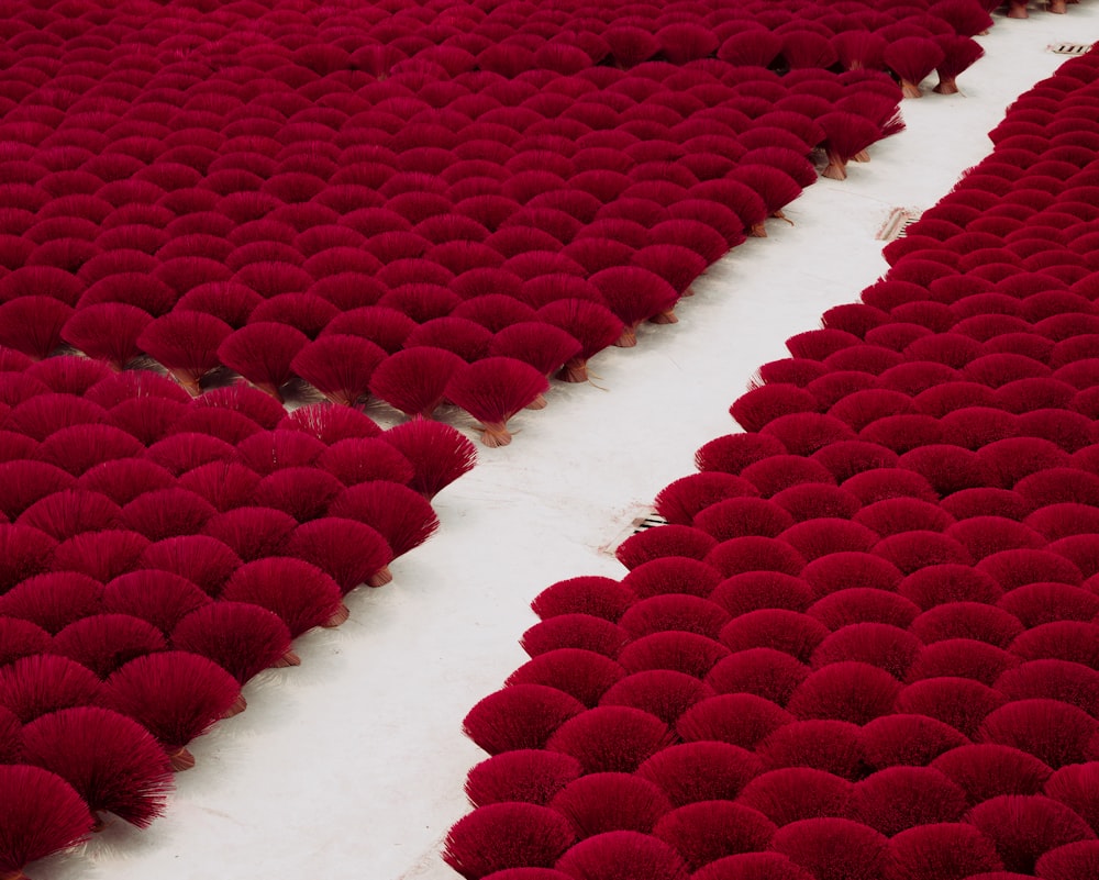 a large number of red balls on a white floor