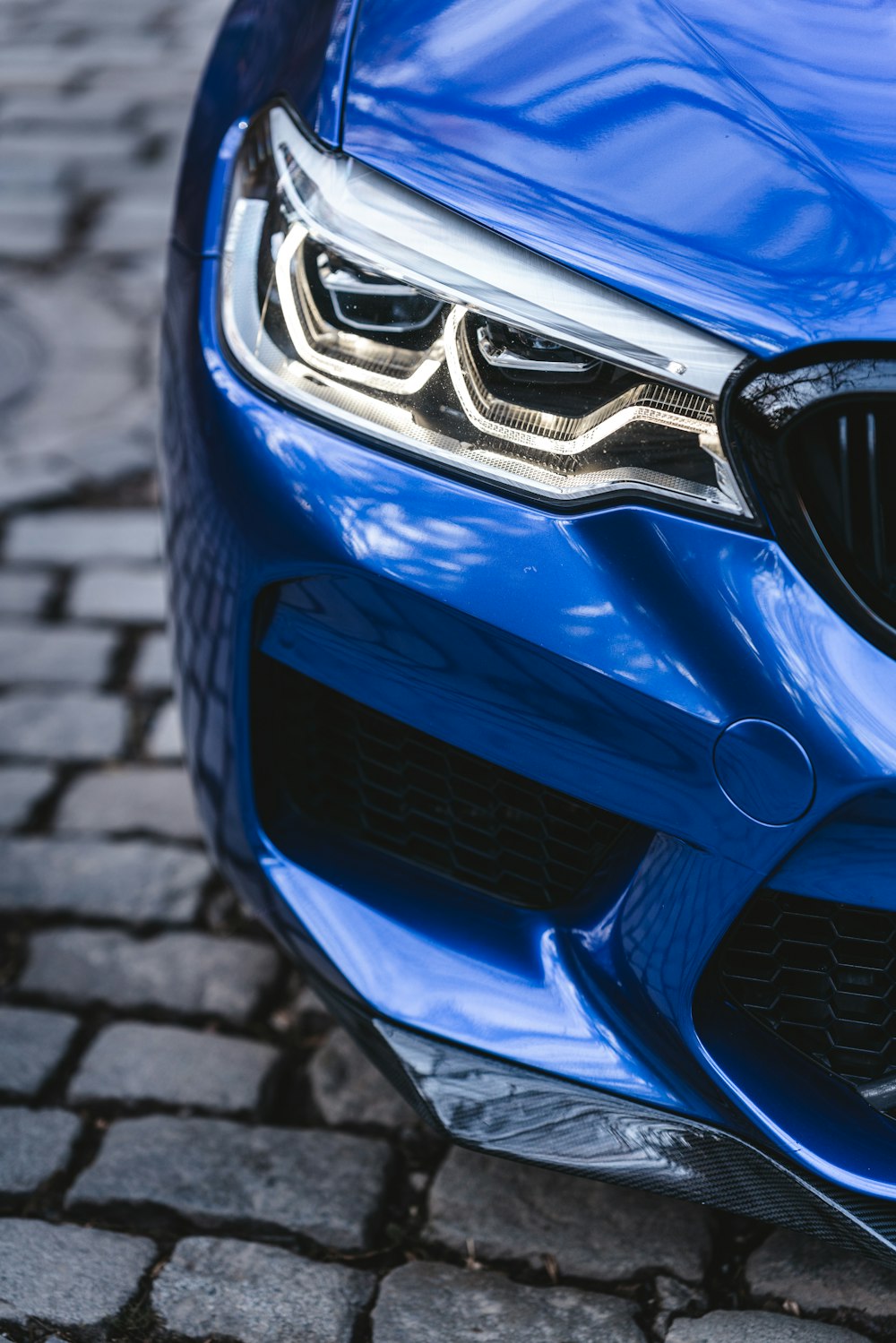 a close up of the front of a blue car