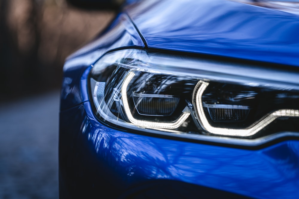 a close up of the front lights of a blue car