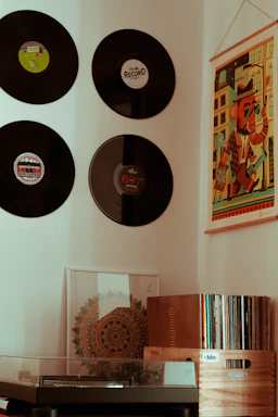 A cozy studio corner with vintage microphones and vinyl records stacked nearby.