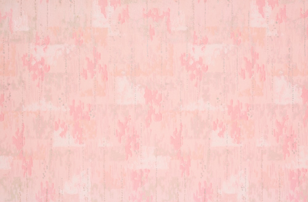 a pink and beige wall with a pattern on it