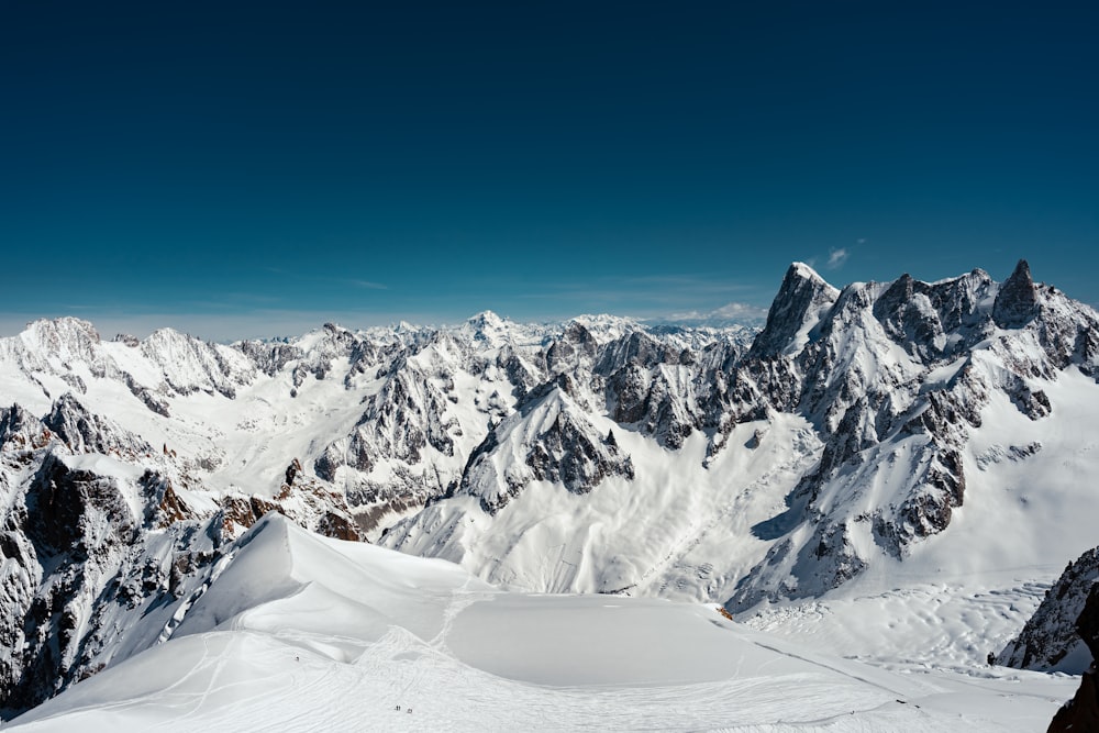 a view of a mountain range with snow on it