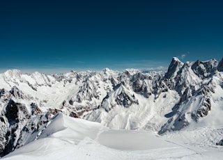 a view of a mountain range with snow on it