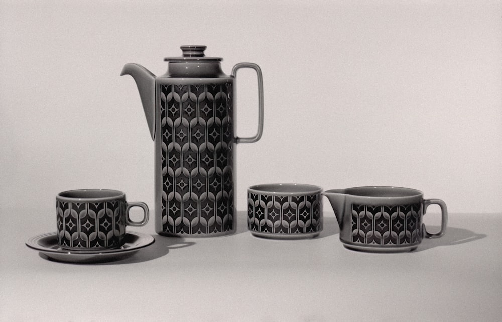 a black and white photo of a tea set