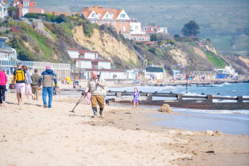 a group of people walking along a sandy beach