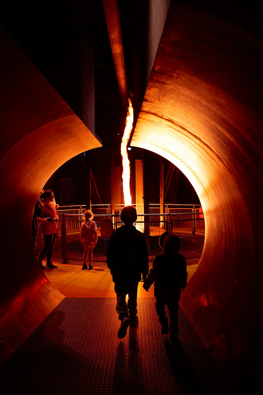 a couple of people that are walking in a tunnel