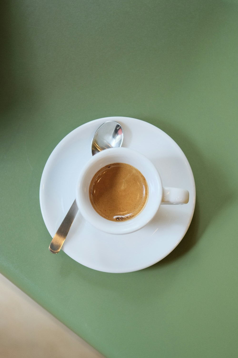 a cup of coffee sitting on top of a white saucer