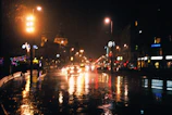 A moody nighttime cityscape with subtle glowing lights reflecting off wet streets.
