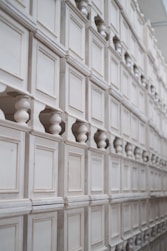 a wall of white cabinet doors and knobs