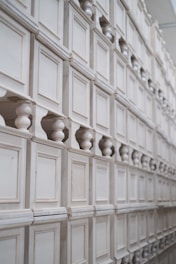 a wall of white cabinet doors and knobs