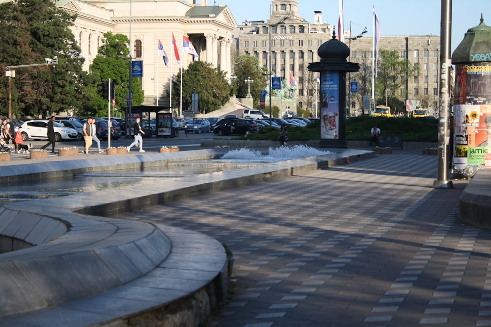 a city street with a fountain in the middle of it