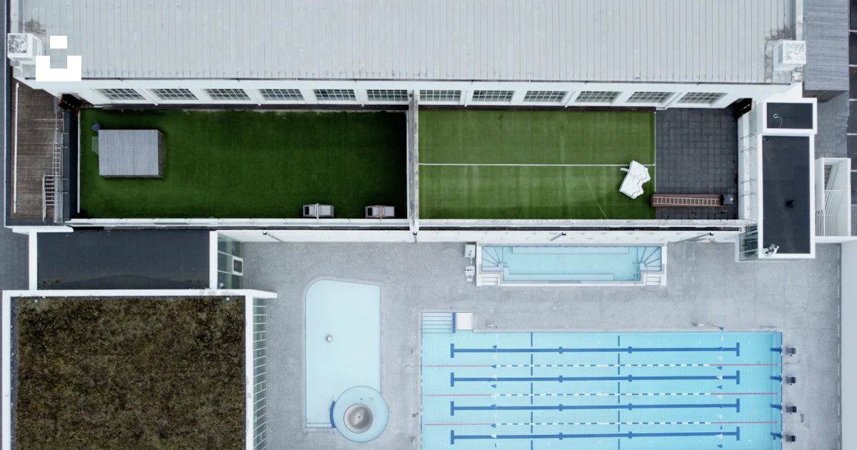 An aerial view of a swimming pool in a building photo – Free ...