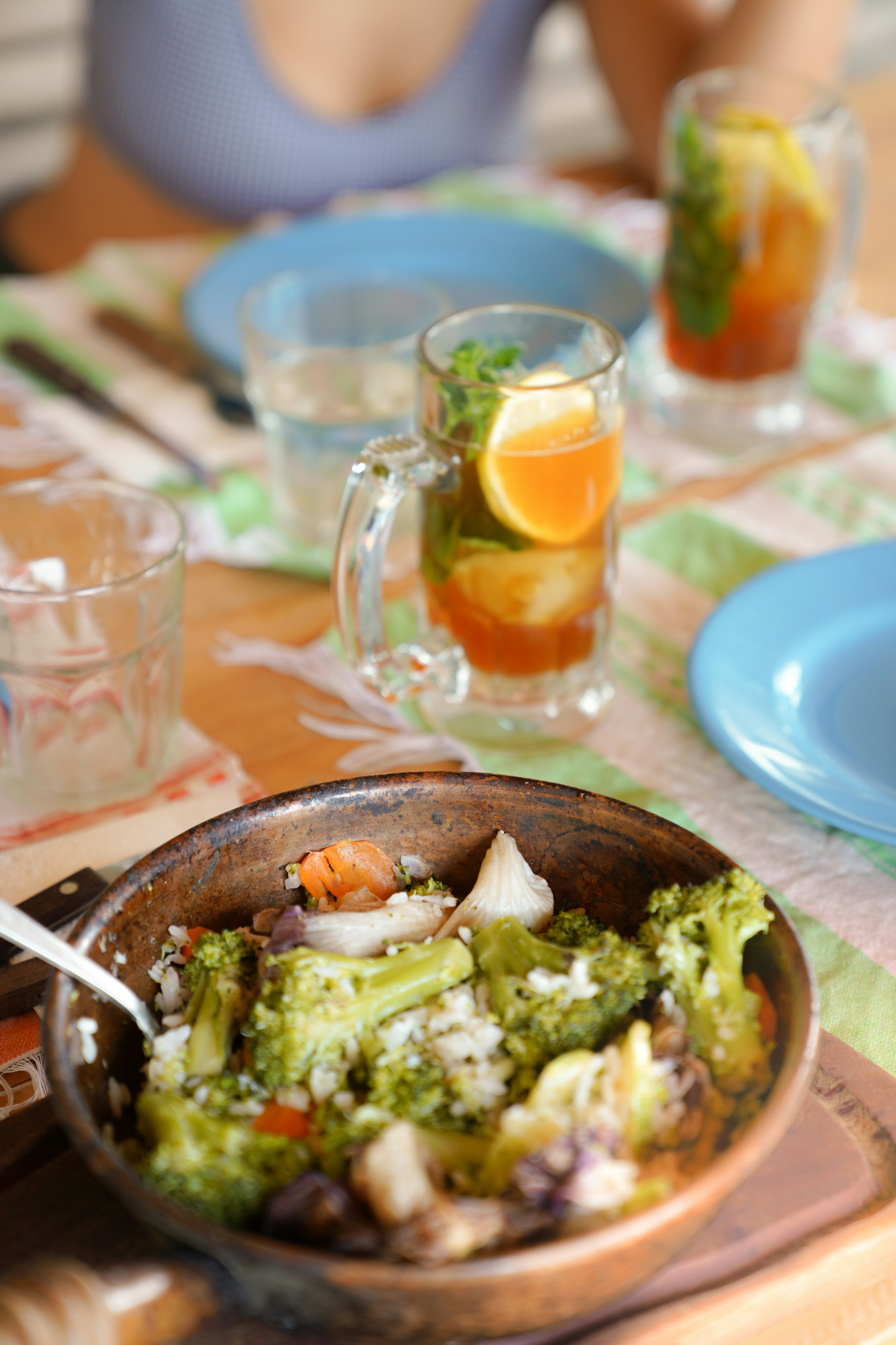 a bowl of broccoli and other food on a table