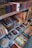Shelves filled with a variety of incense products, each neatly packed in colorful boxes. The items are organized by brand and type, with price labels visible on the shelves. Decorative elements and promotional signs add to the inviting display.