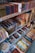Shelves filled with a variety of incense products, each neatly packed in colorful boxes. The items are organized by brand and type, with price labels visible on the shelves. Decorative elements and promotional signs add to the inviting display.