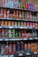 Selection of Ambev beverages including beer cans and bottles arranged on a shelf.