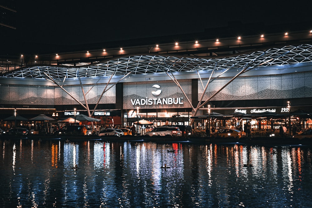 a large building with a lit up sign on it's side