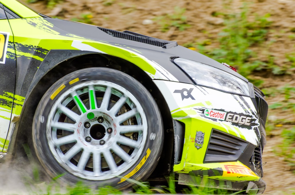 a close up of a car driving on a dirt road