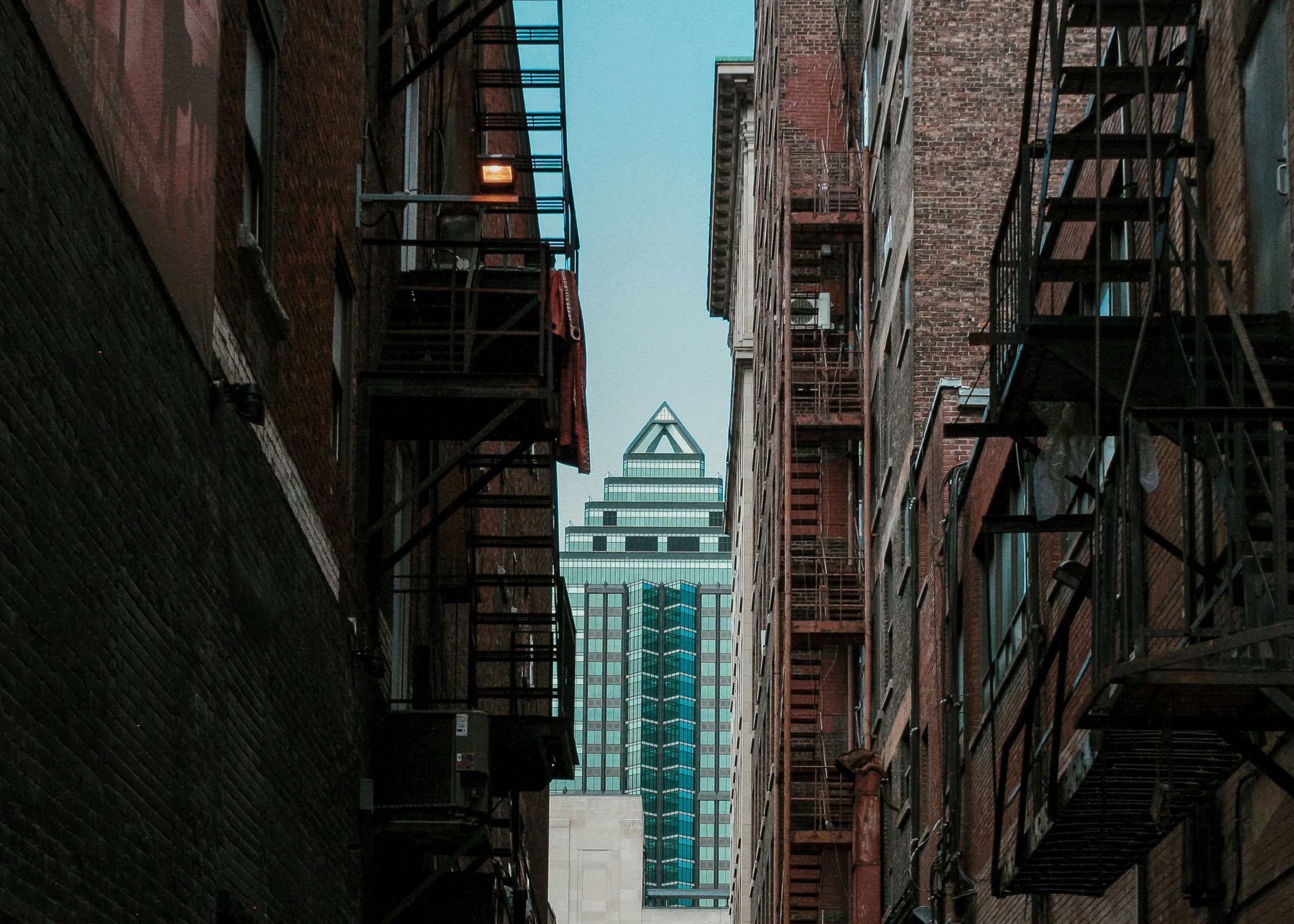 a city street with a tall building in the background
