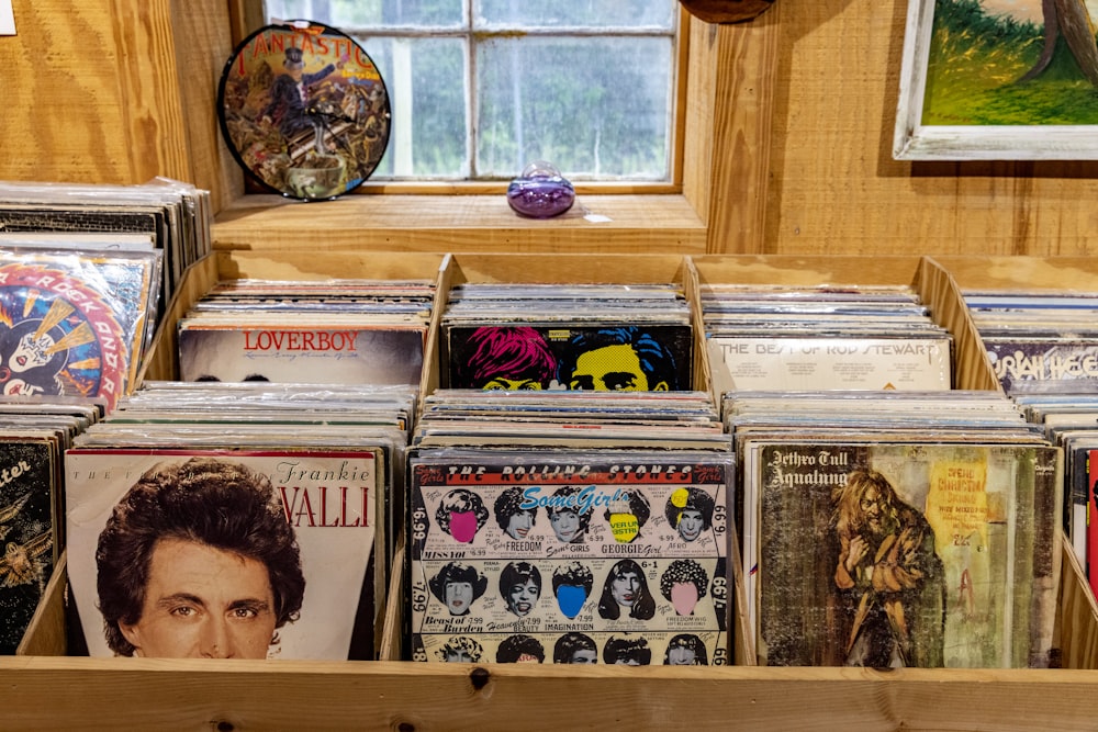 a collection of records on a shelf in a room