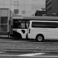 a white bus parked on the side of the road