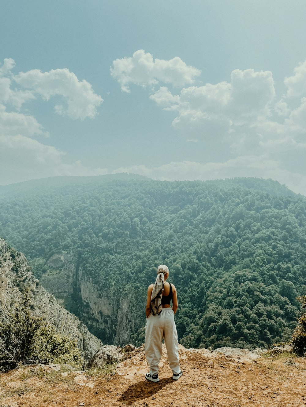 a person standing on top of a mountain with a backpack