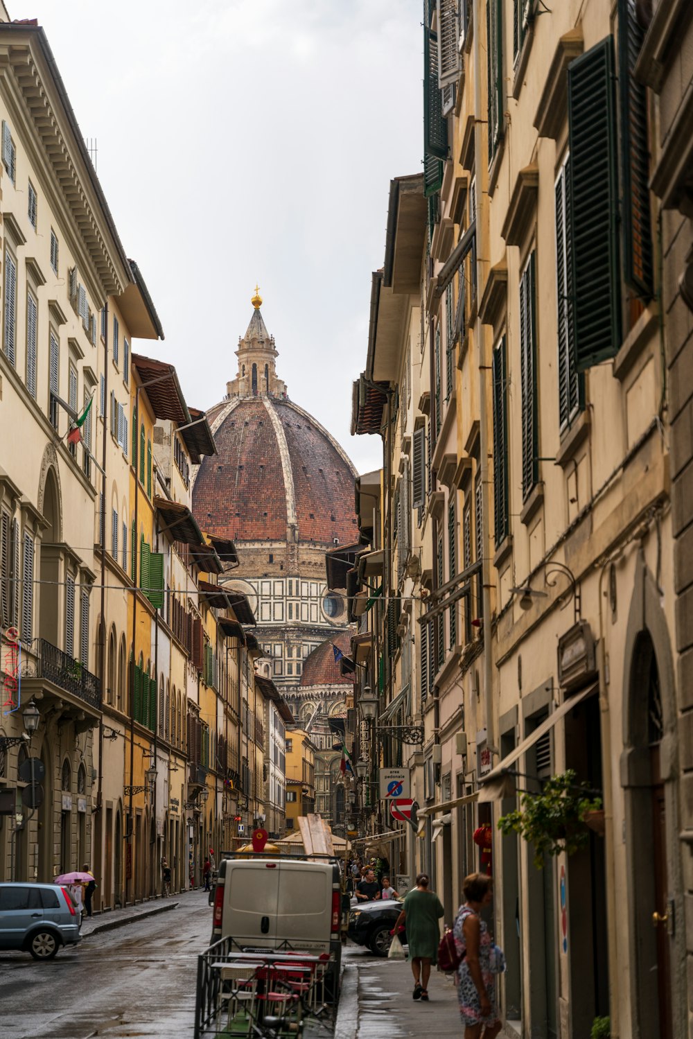 a city street with buildings and a dome in the background