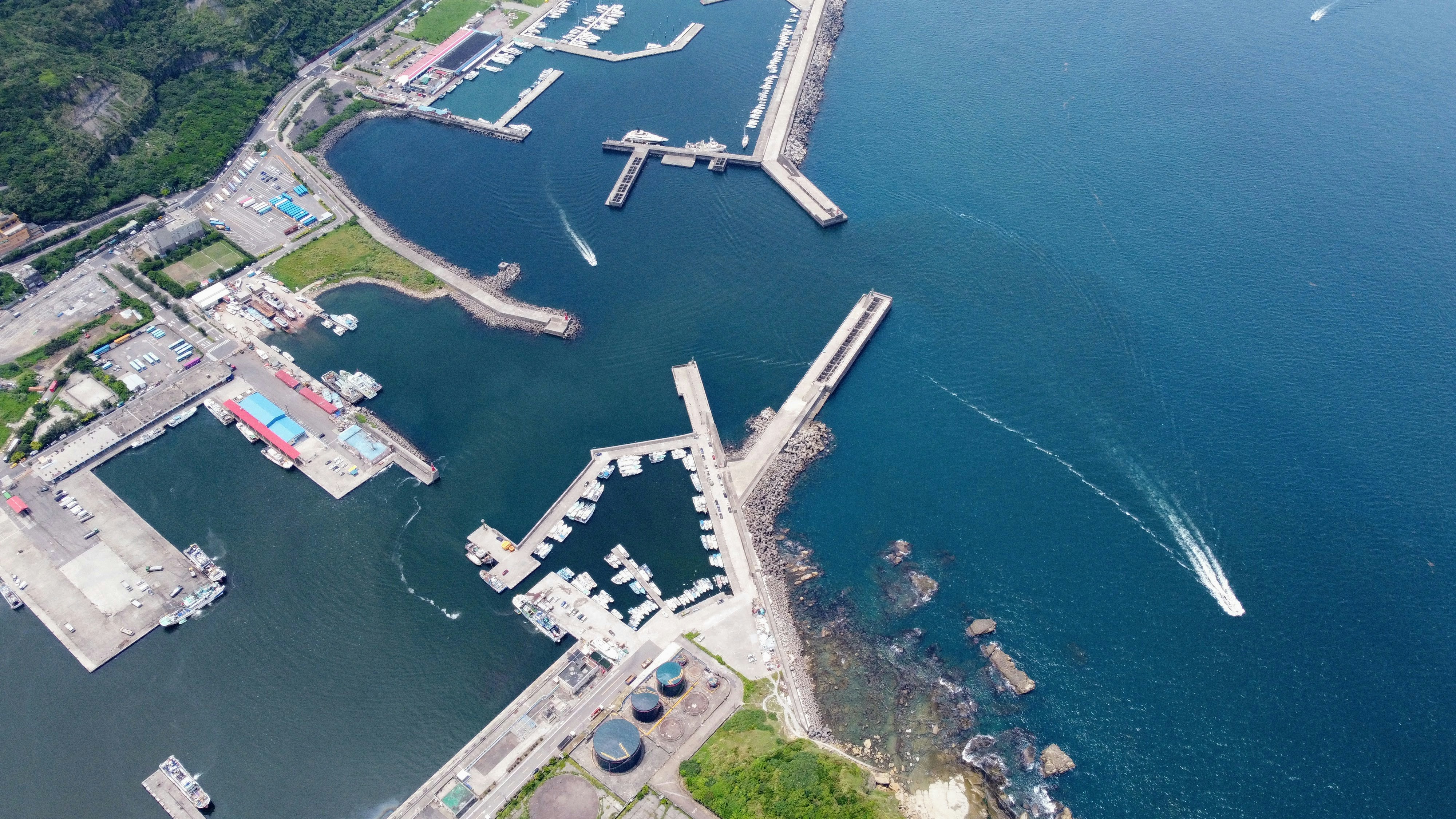 an aerial view of a harbor with boats in the water