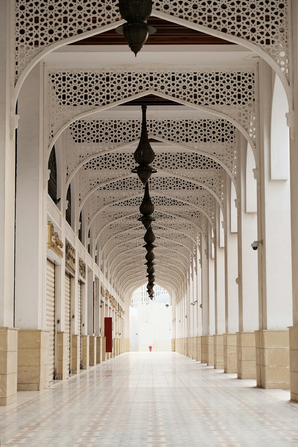 a long hallway with a clock on the ceiling