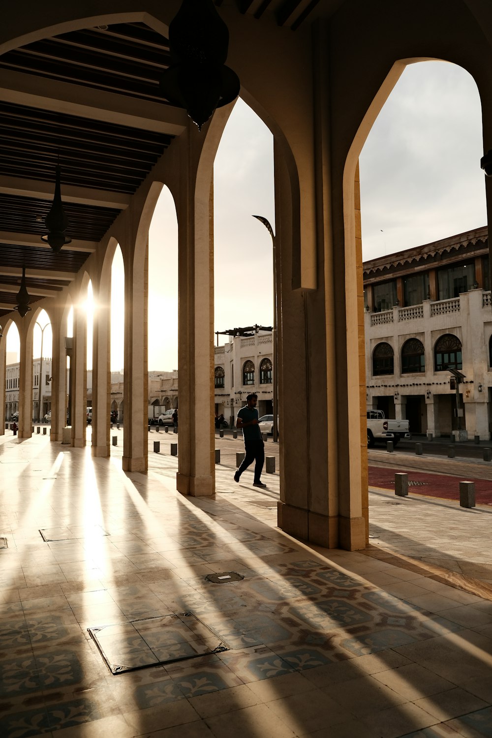 a person walking down a street next to a building