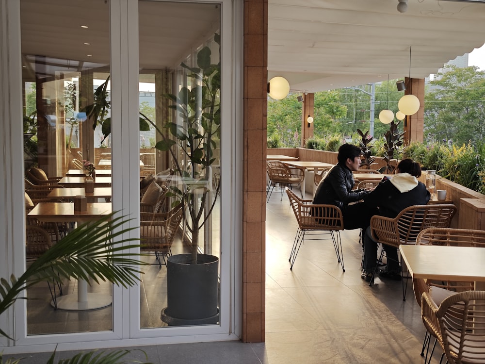 a couple of people sitting at a table in a restaurant