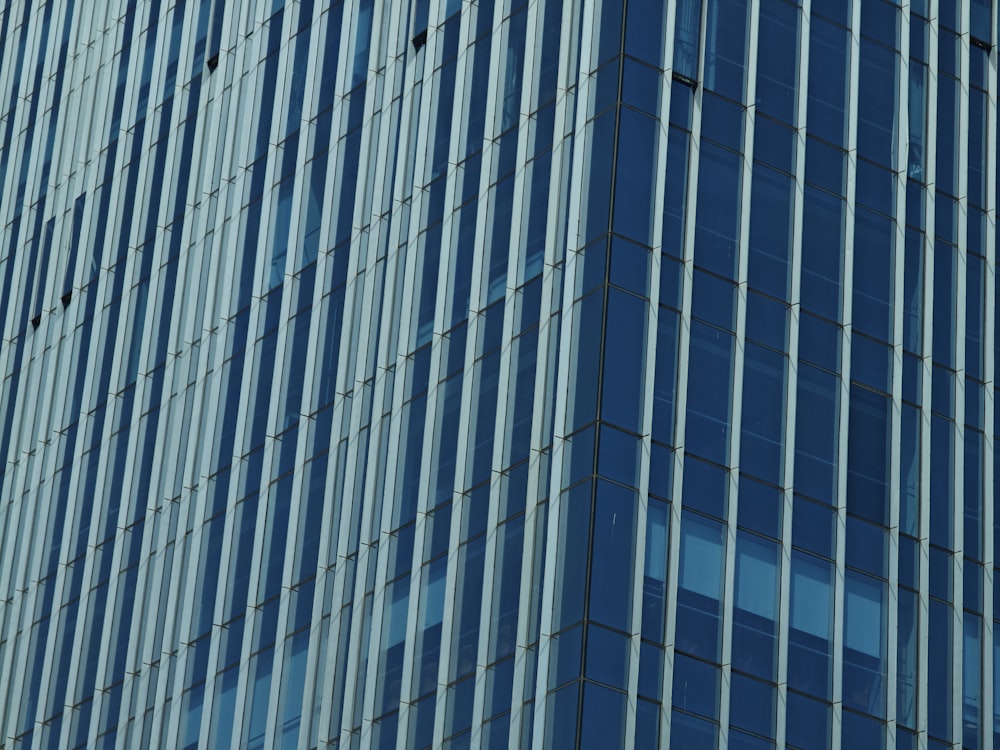 an airplane is flying in front of a tall building