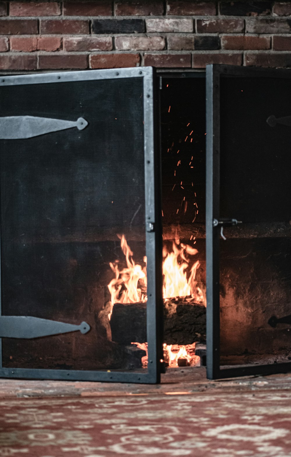 a fire burning inside of a metal oven