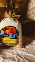 A colorful mix of dried berries spilling from a burlap sack onto a natural linen cloth.