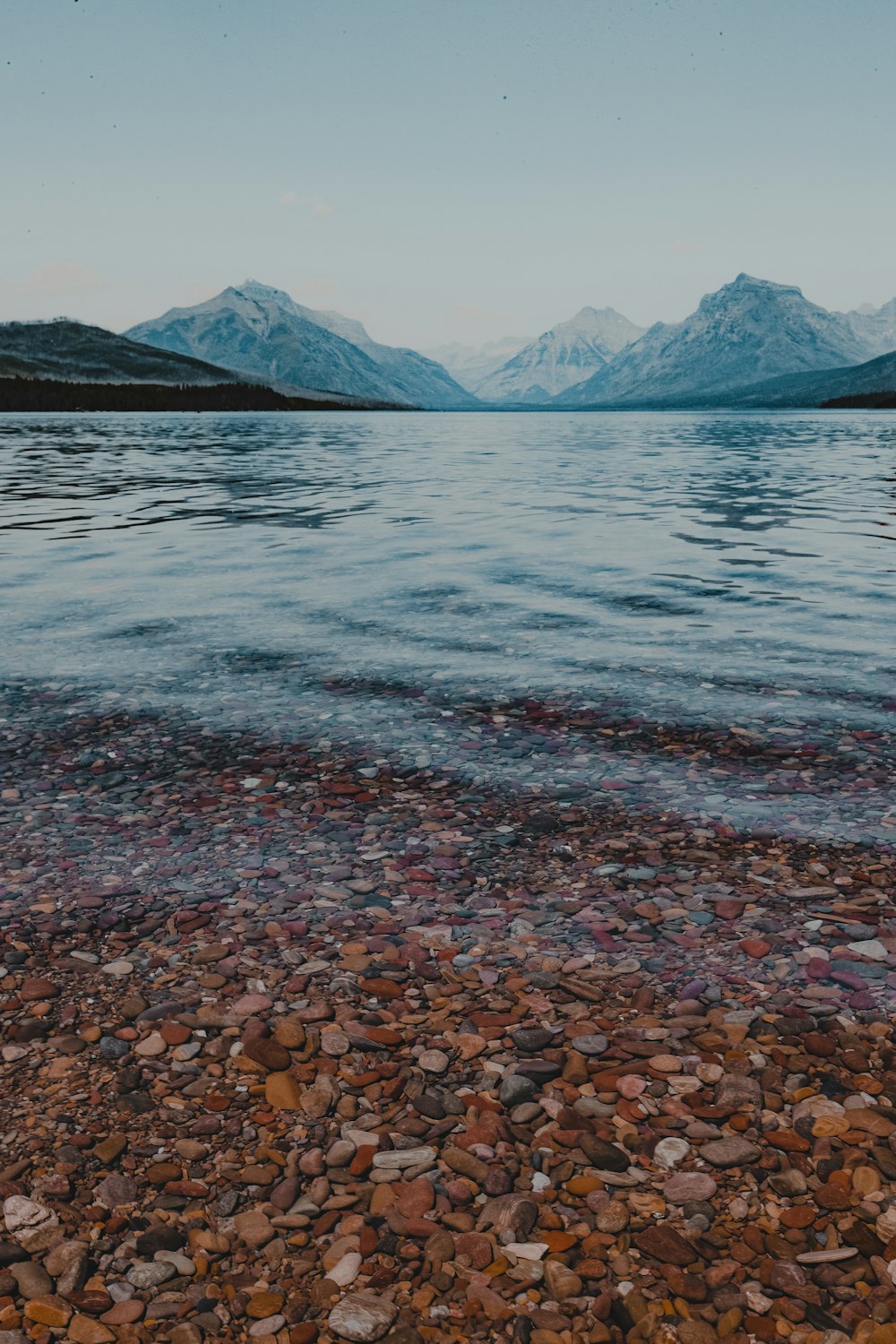 a body of water with mountains in the background