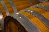 A close-up of a beautifully aged oak barrel.