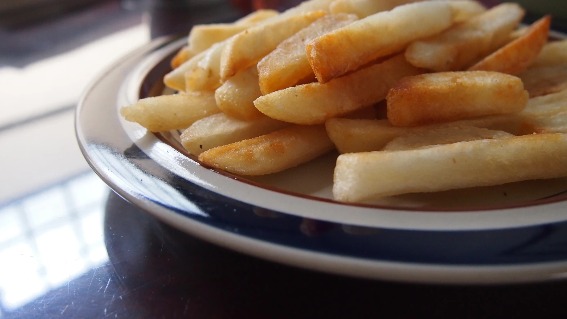 a plate of french fries on a table