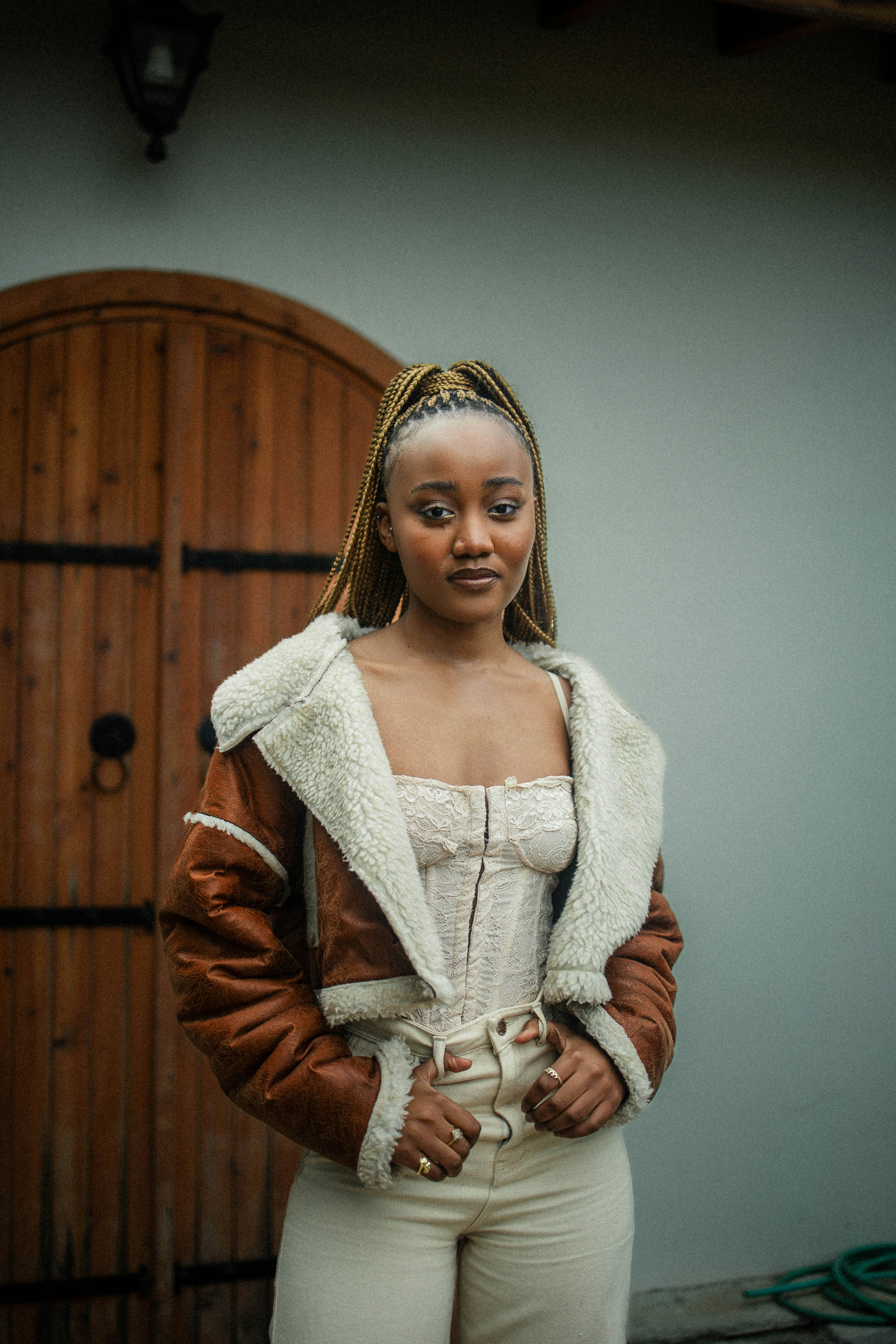 a woman standing in front of a wooden door