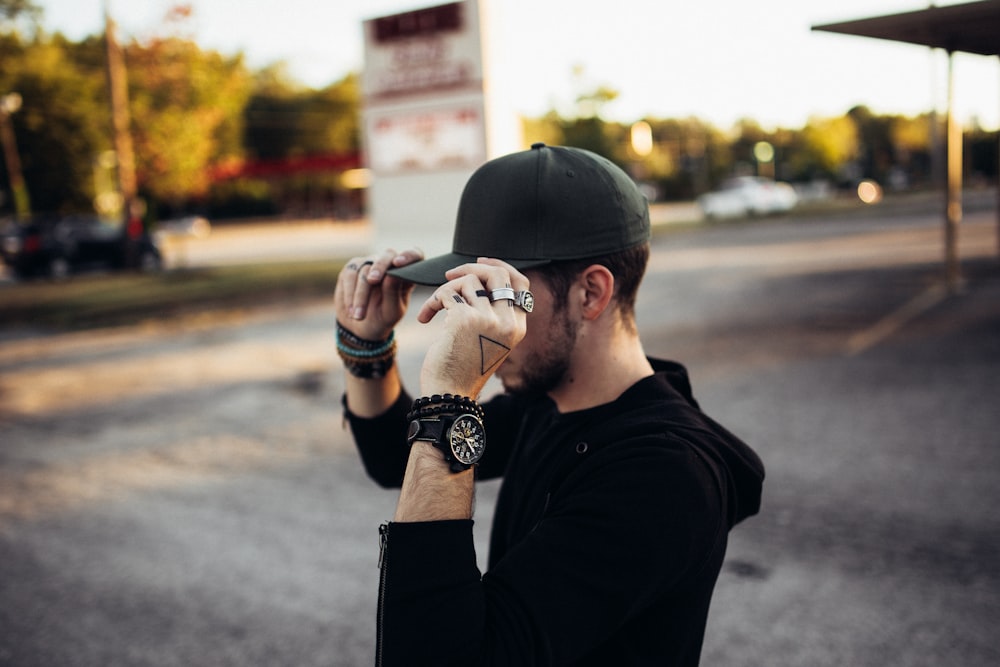 a man in a black shirt is taking a picture