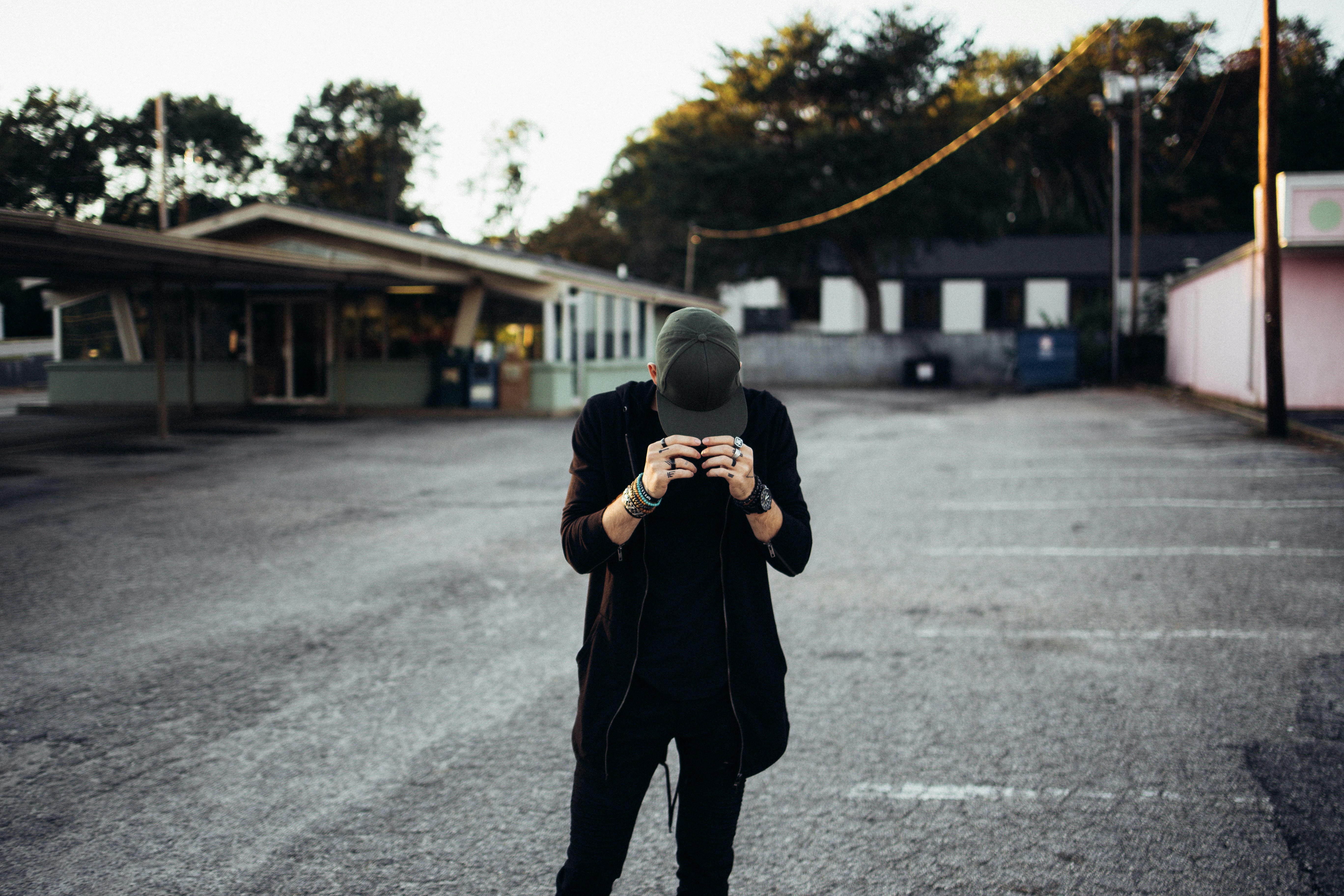 A man standing in a parking lot holding a camera
