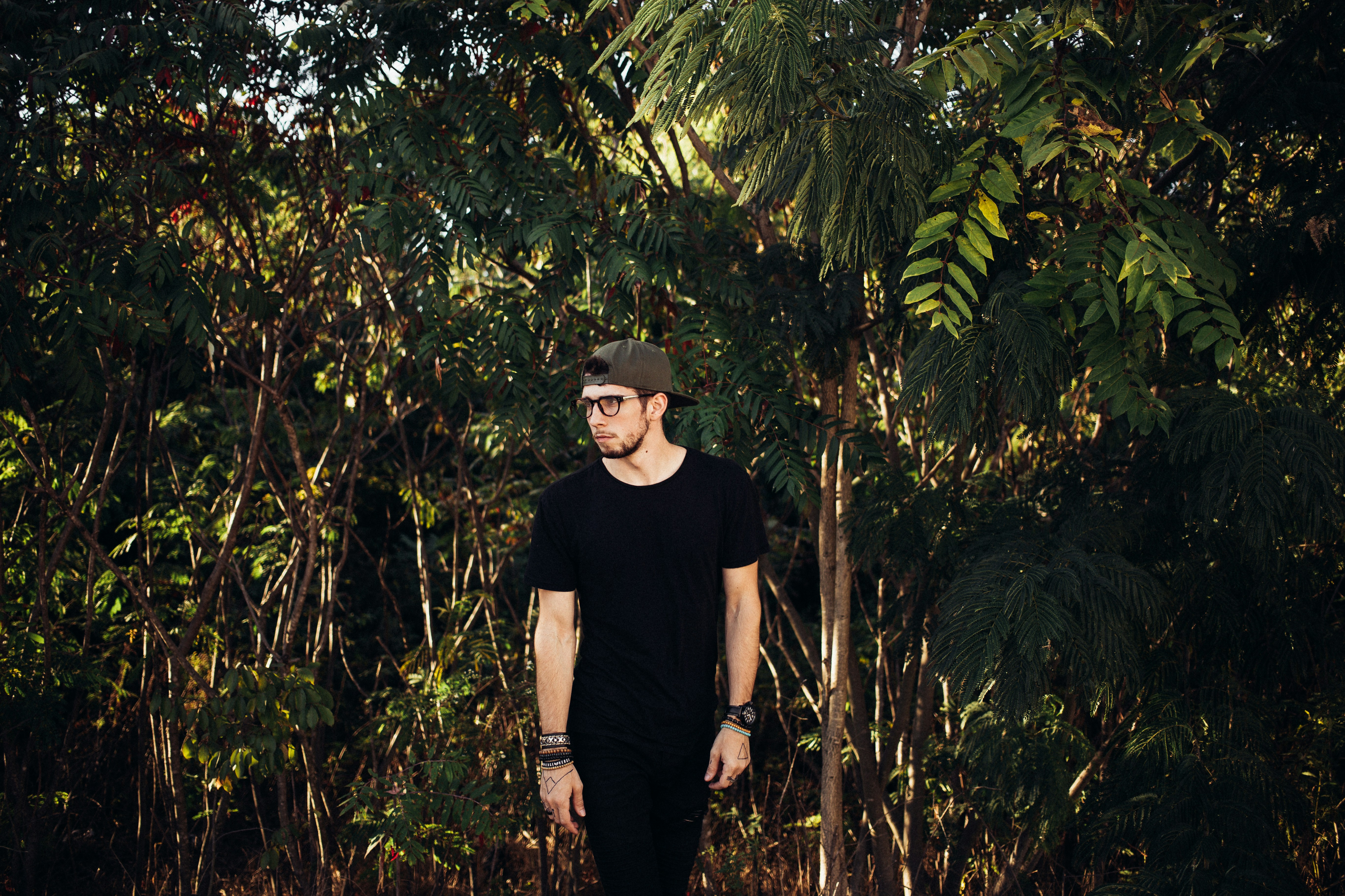 A man standing in front of a forest