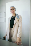 Close-up of a plus-size model in a chic, tailored blazer with bold accessories